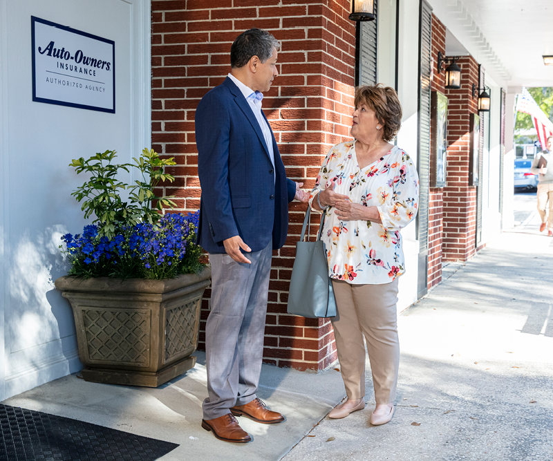 a man and a woman standing on a sidewalk