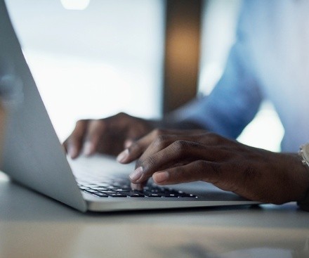 A person typing on a laptop.
