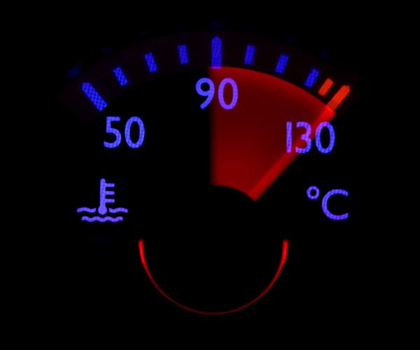 A gauge with an oil temperature symbol on the left and a Celsius degree symbol on the right on a black background. A red needle is pointing at 130 degrees Celsius.