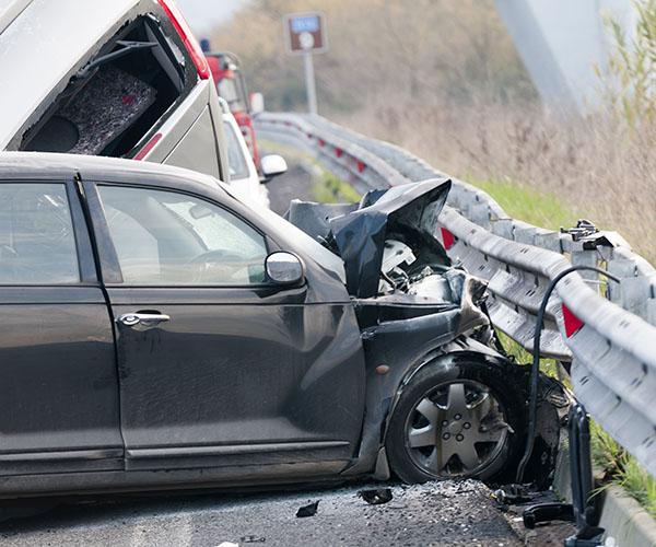 A gray sedan crashed into a guardrail.