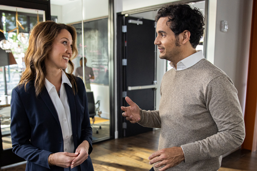 Two people standing having a conversation.